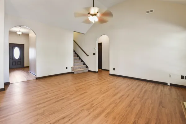 a view of empty room with wooden floor
