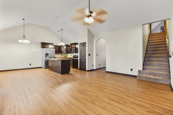 a view of a kitchen with a stove cabinets wooden floor and a ceiling fan