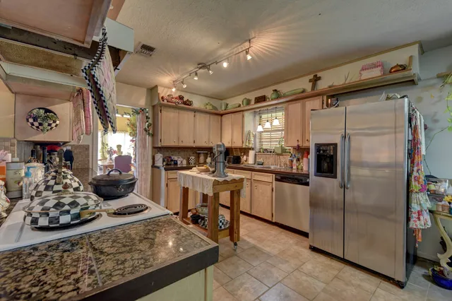 a kitchen with a refrigerator and a sink