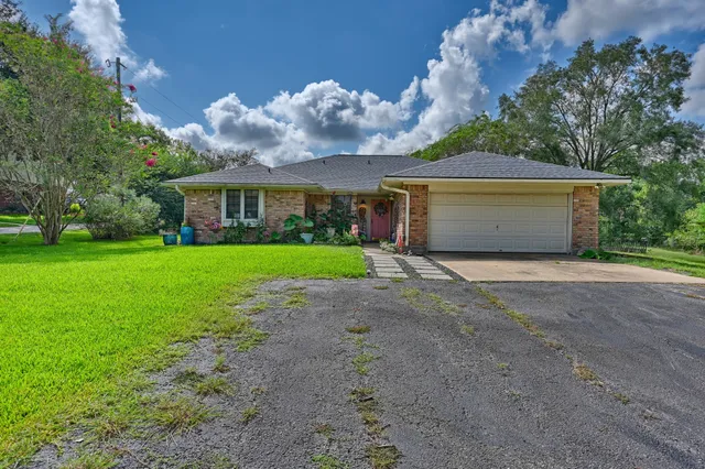 a front view of house with yard and green space