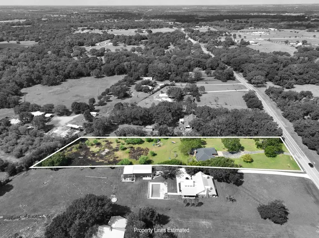 an aerial view of a houses with a yard
