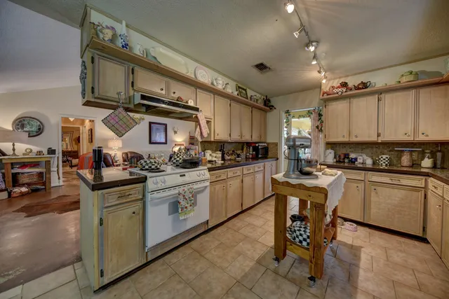 a kitchen with stainless steel appliances granite countertop a sink and cabinets