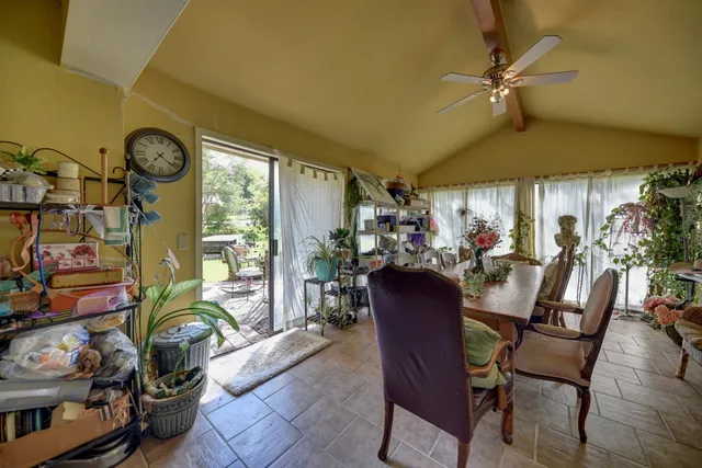 a view of a dining room with furniture and a chandelier