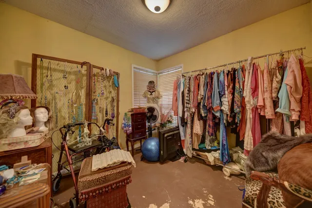 a view of walk in closet with clothes