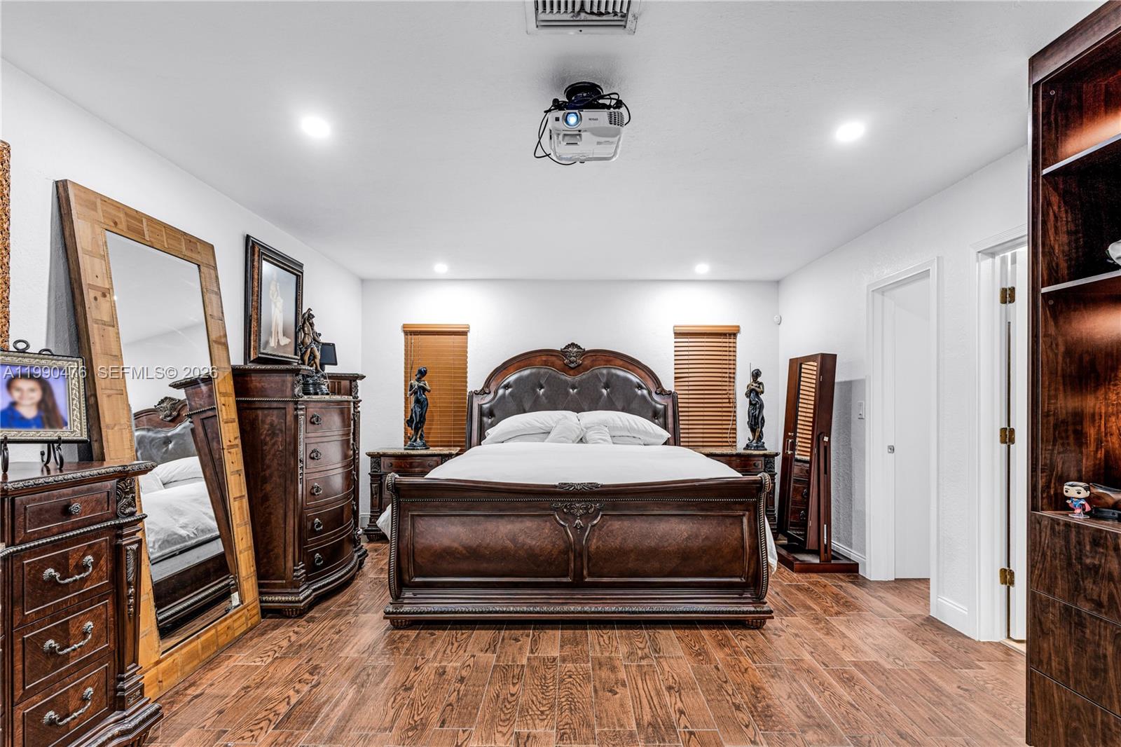 18851 Southwest 218th Street Miami, FL 33170 - Photo 12 of 27 a bedroom with bed and wooden floor