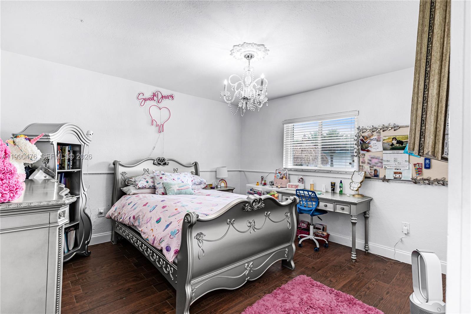 18851 Southwest 218th Street Miami, FL 33170 - Photo 16 of 27 a bedroom with a bed table chair and a window