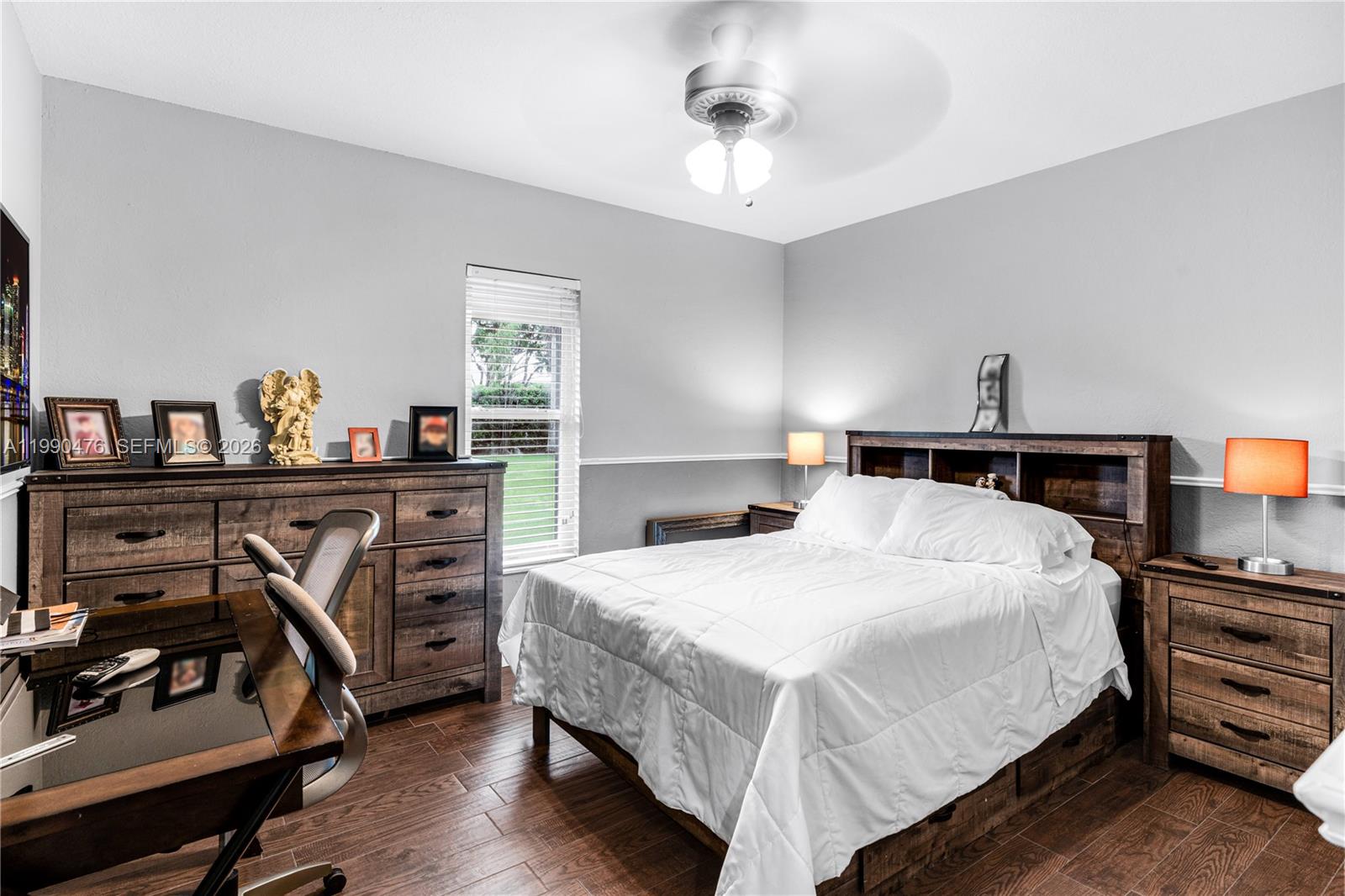 18851 Southwest 218th Street Miami, FL 33170 - Photo 17 of 27 a bedroom with a bed and wooden floor