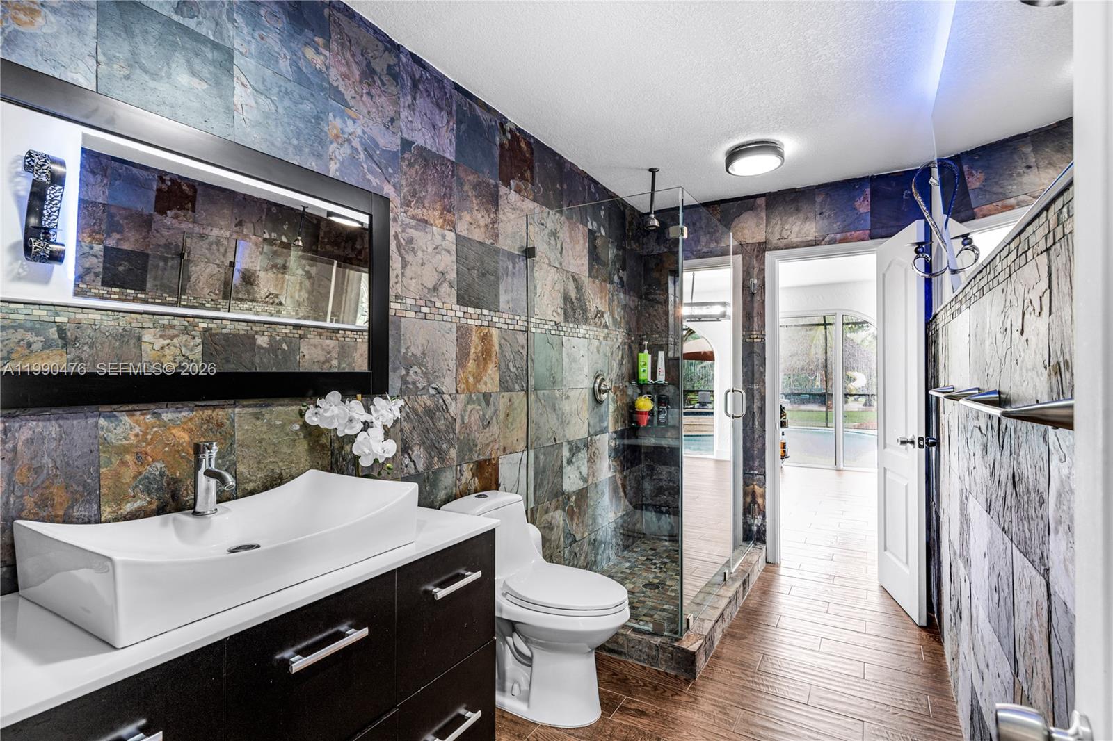 18851 Southwest 218th Street Miami, FL 33170 - Photo 19 of 27 a bathroom with a sink a toilet and shower