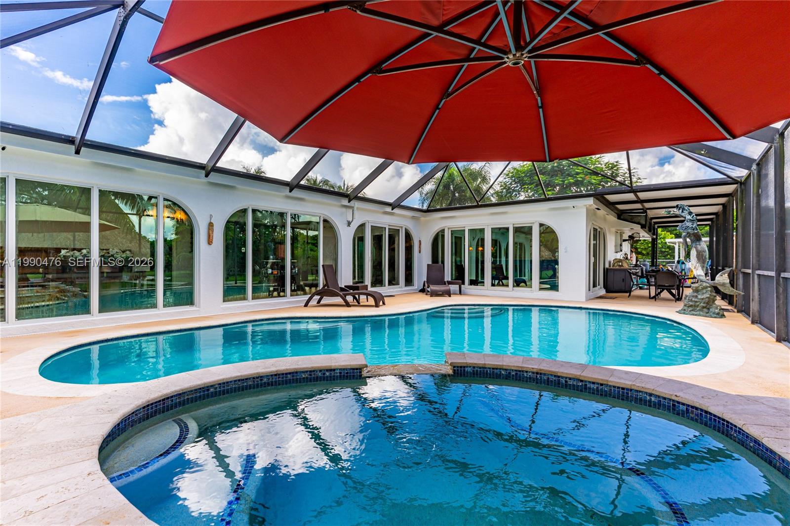 18851 Southwest 218th Street Miami, FL 33170 - Photo 20 of 27 a view of a patio with a table and chairs under an umbrella