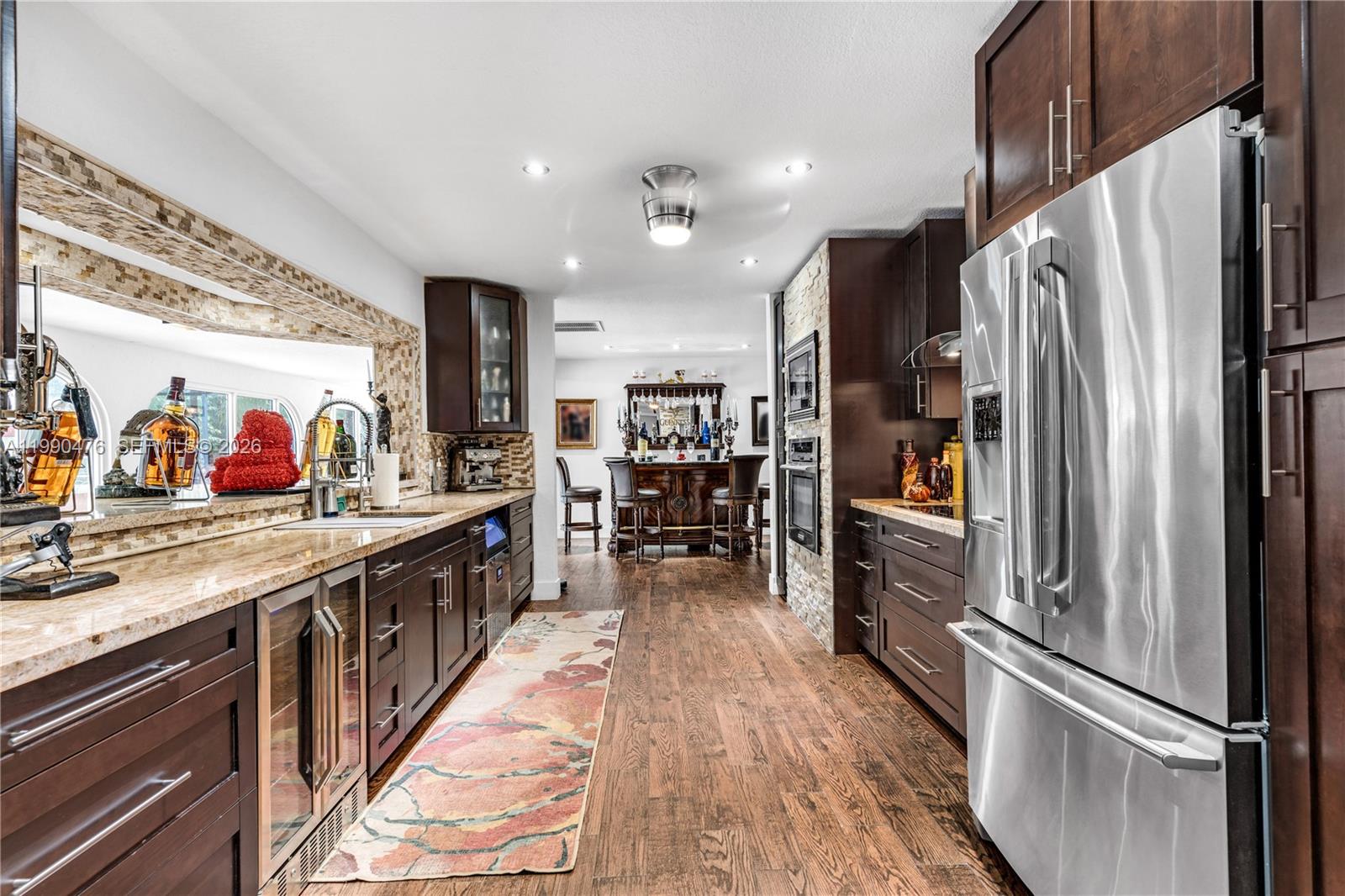 18851 Southwest 218th Street Miami, FL 33170 - Photo 7 of 27 a kitchen with stainless steel appliances a refrigerator and a sink