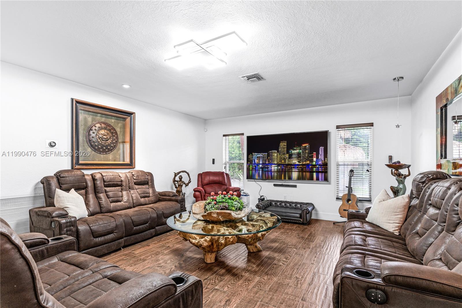 18851 Southwest 218th Street Miami, FL 33170 - Photo 8 of 27 a living room with furniture and a flat screen tv
