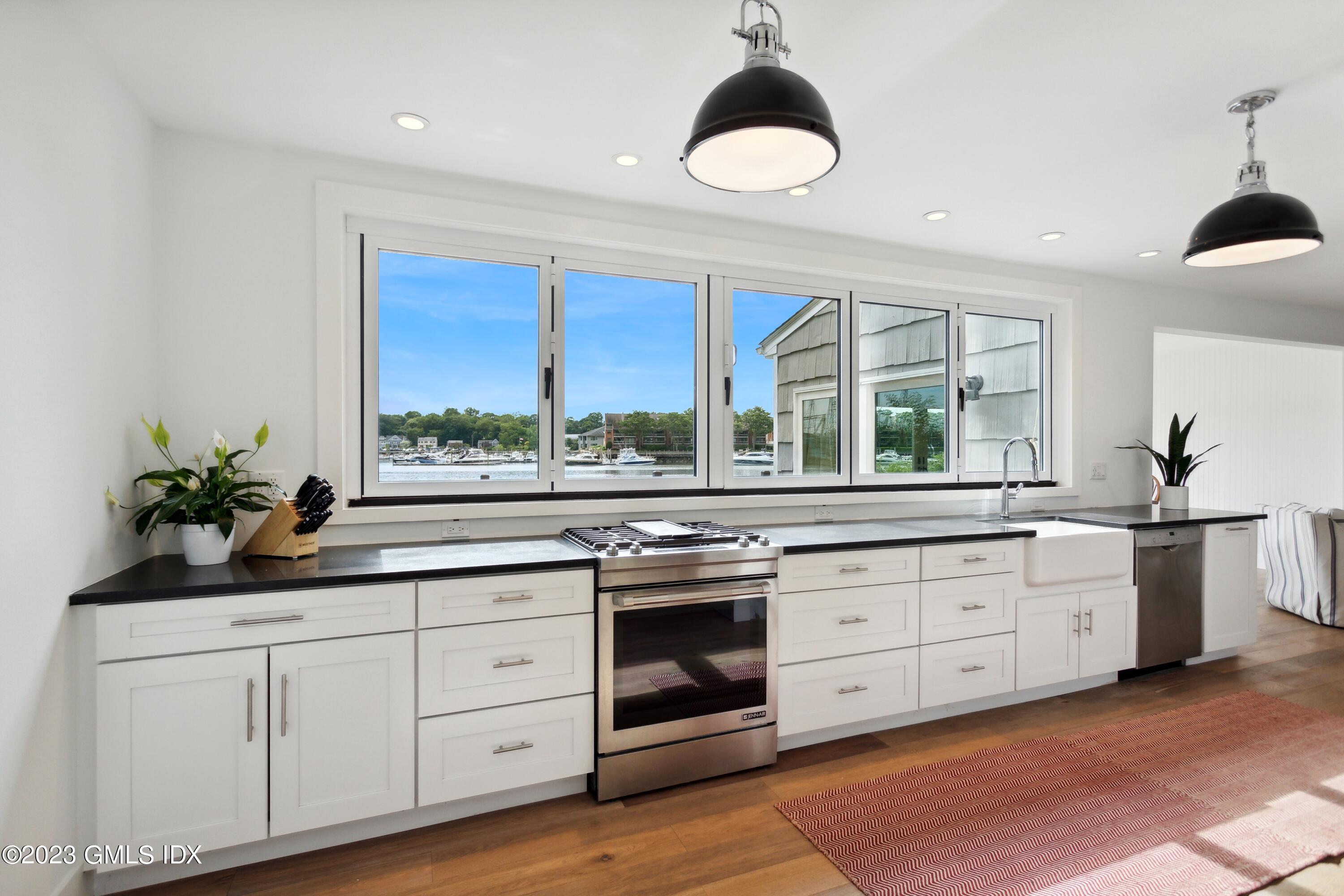 40 Chapel Lane Riverside, CT 06878 - Photo 11 of 35 a kitchen with a white stove top oven and sink