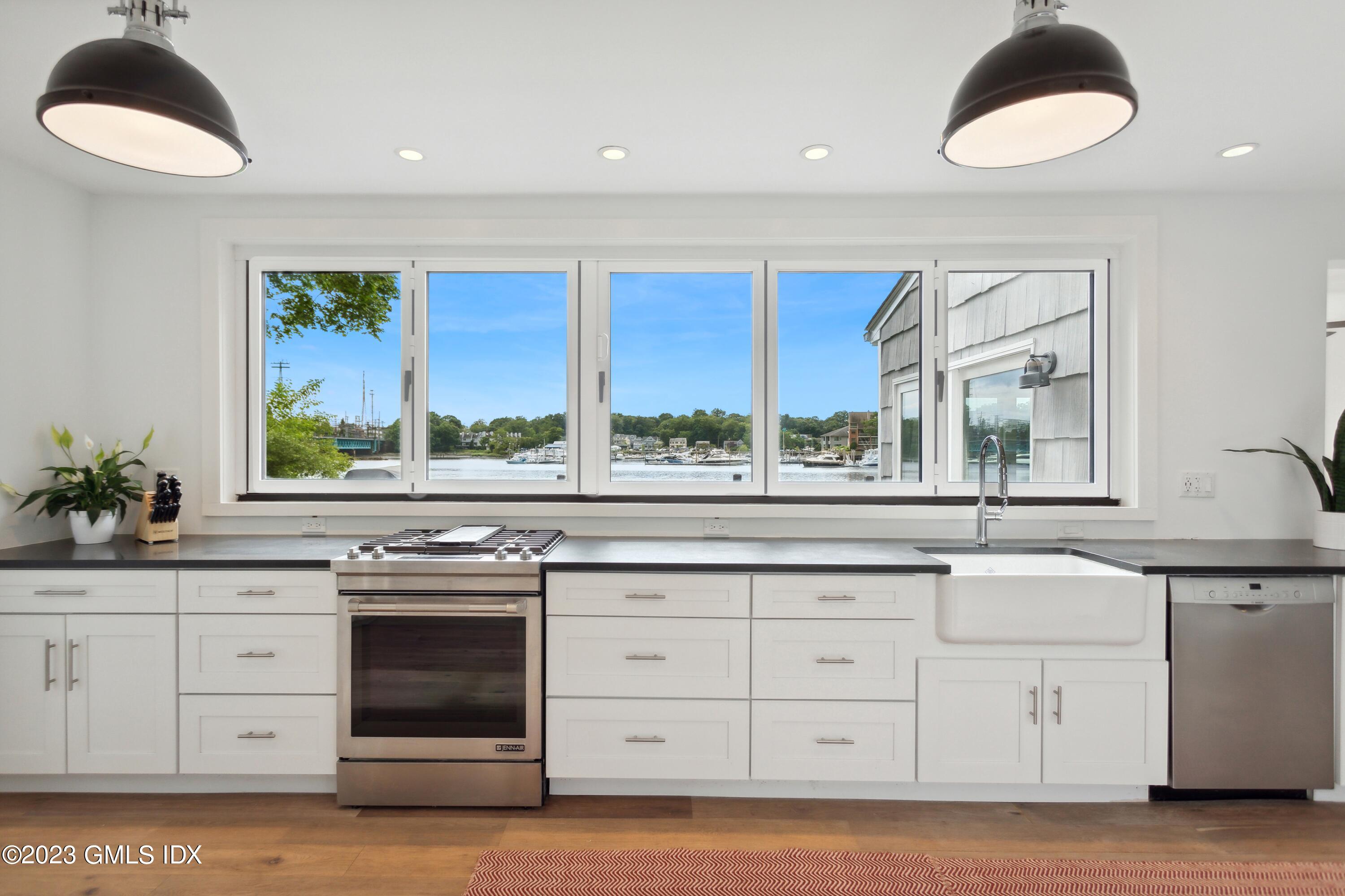 40 Chapel Lane Riverside, CT 06878 - Photo 12 of 35 a kitchen with stainless steel appliances granite countertop a stove and a sink