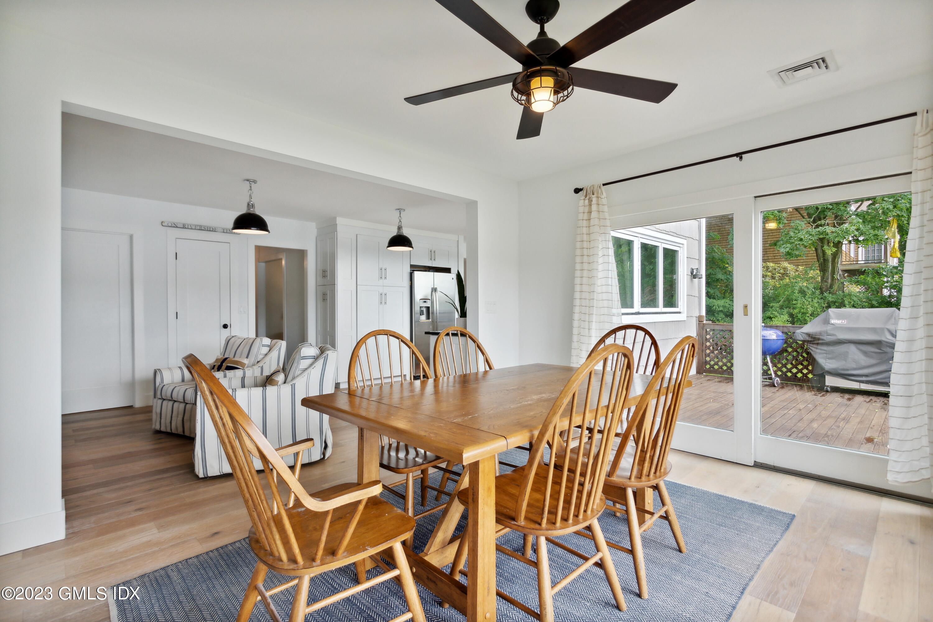 40 Chapel Lane Riverside, CT 06878 - Photo 16 of 35 a dining room with furniture a chandelier and wooden floor