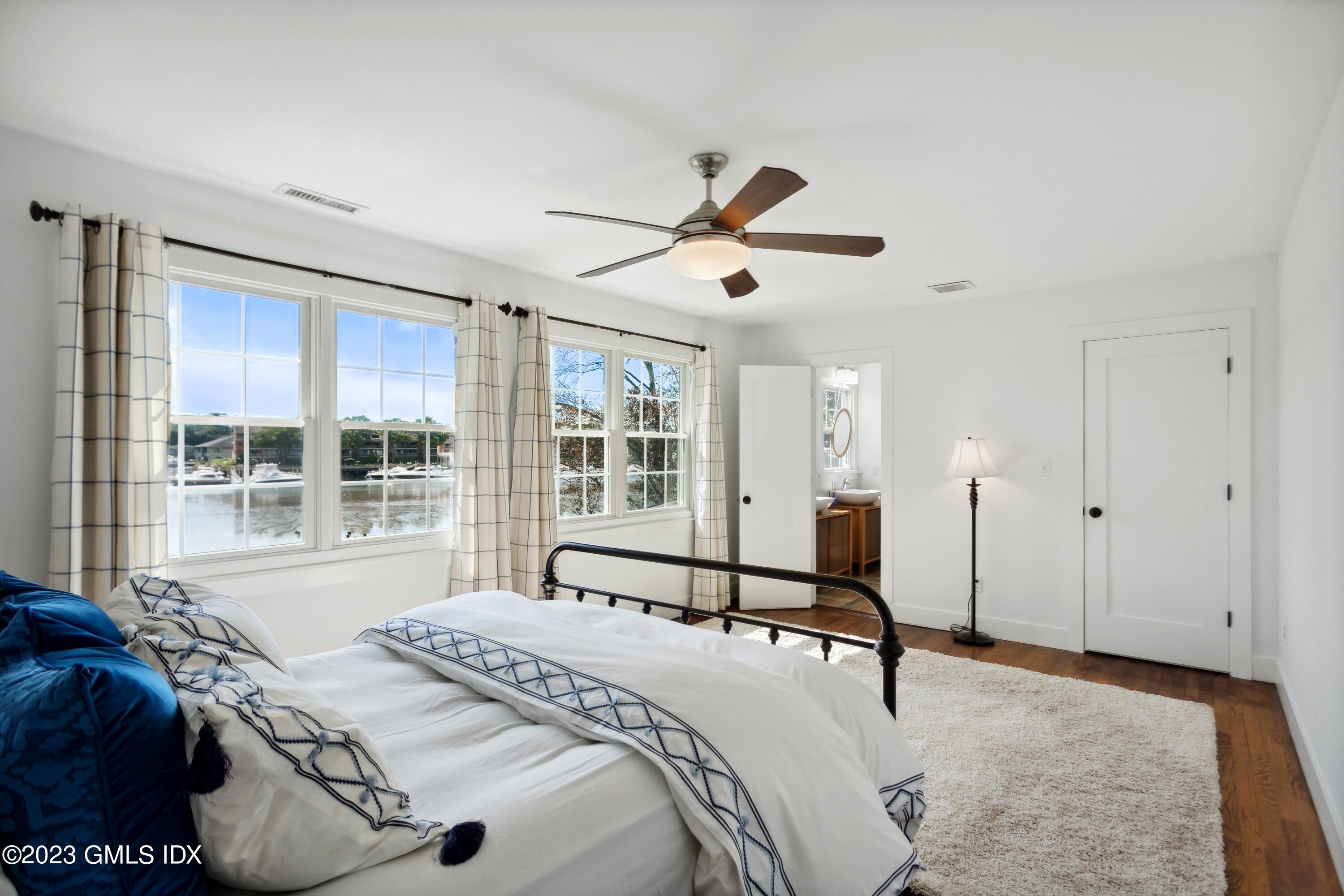 40 Chapel Lane Riverside, CT 06878 - Photo 20 of 35 a bedroom with a bed and a large window with the outer view