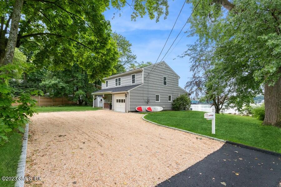 40 Chapel Lane Riverside, CT 06878 - Photo 2 of 35 a front view of a house with a yard and garage