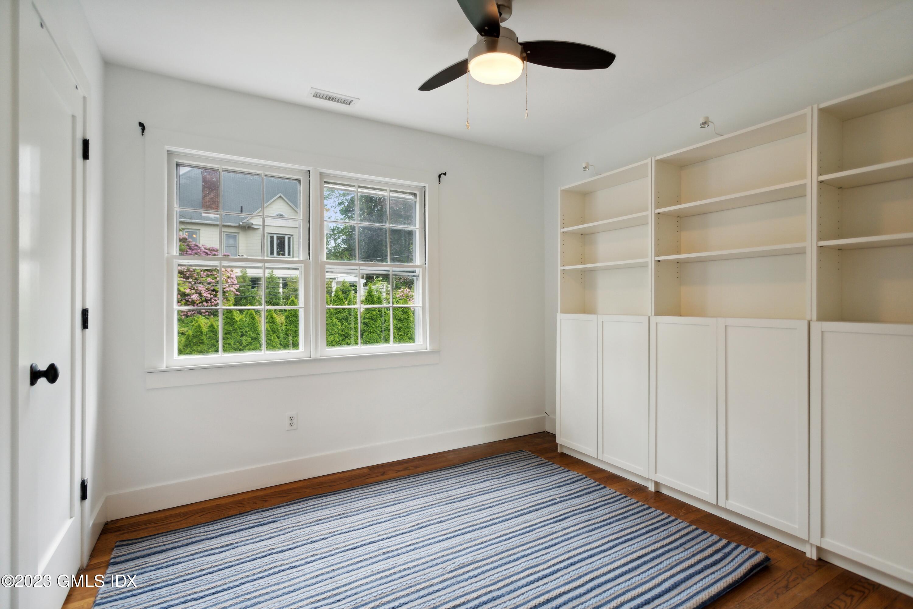 40 Chapel Lane Riverside, CT 06878 - Photo 24 of 35 a view of an empty room with a window and wooden floor
