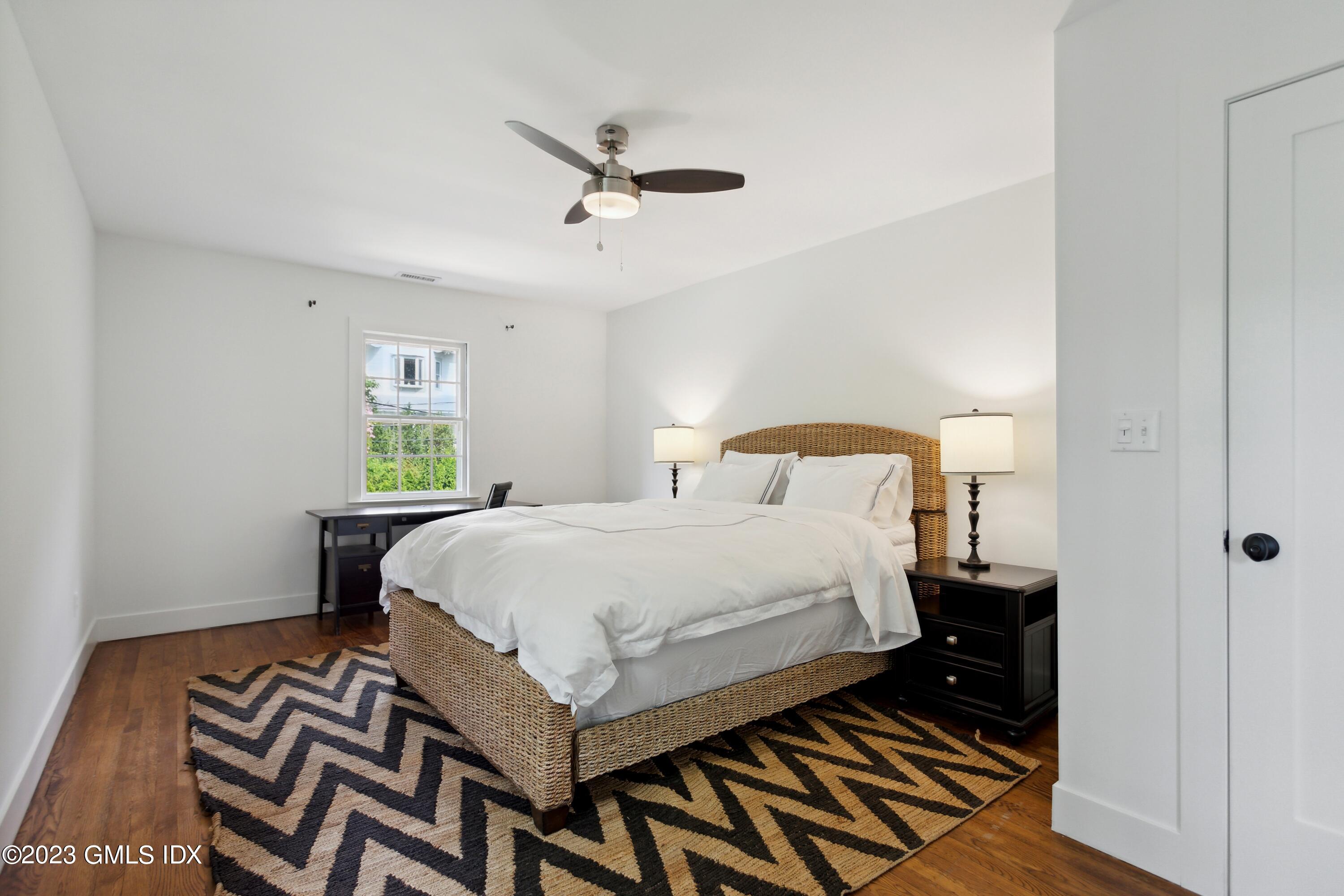 40 Chapel Lane Riverside, CT 06878 - Photo 25 of 35 a bedroom with a bed and wooden floor