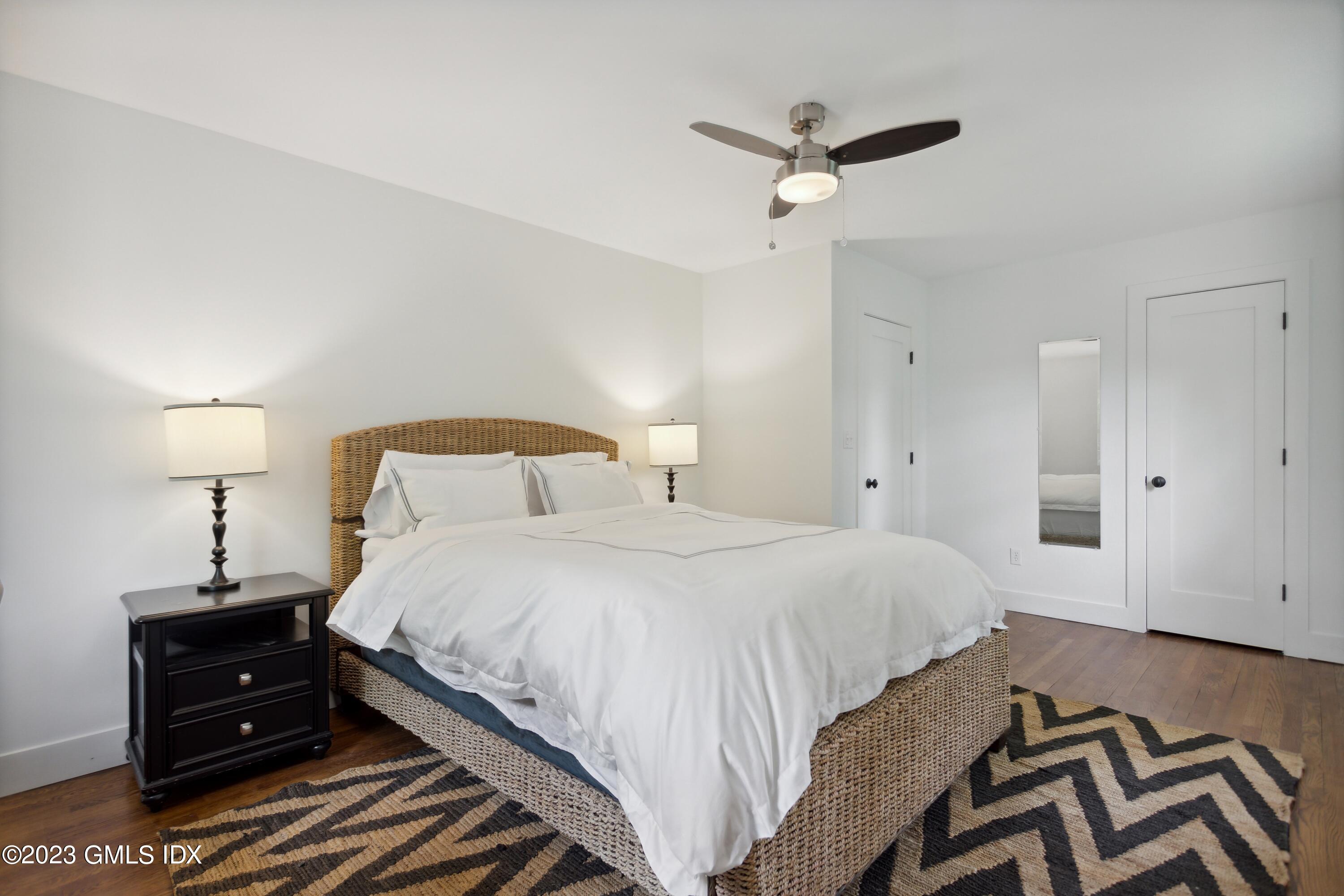 40 Chapel Lane Riverside, CT 06878 - Photo 26 of 35 a bedroom with a bed and a chandelier