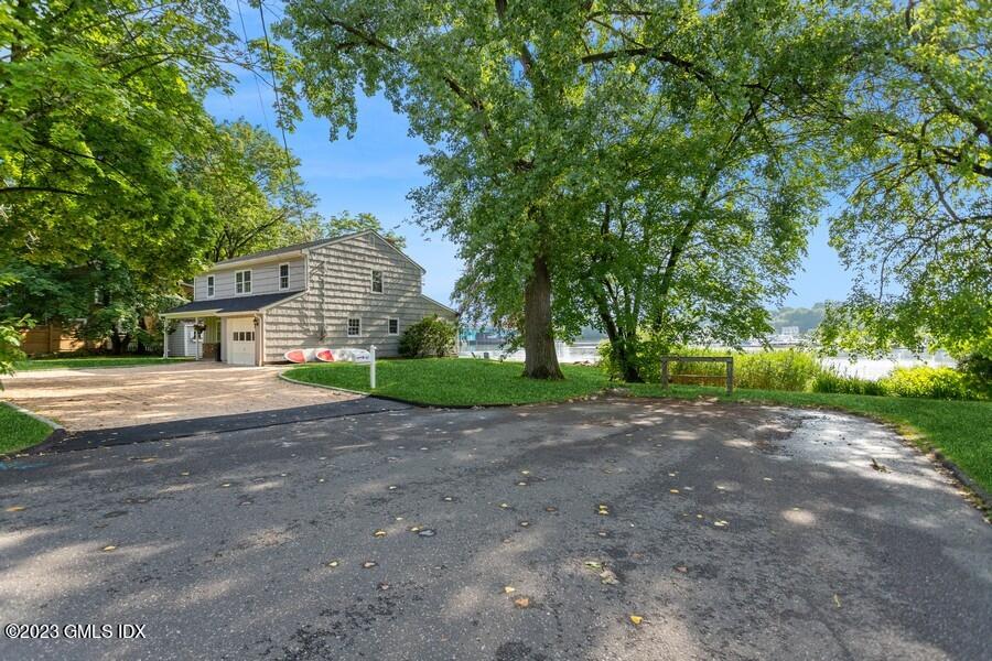 40 Chapel Lane Riverside, CT 06878 - Photo 5 of 35 a view of a house with a big yard and large trees