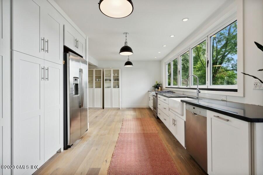 40 Chapel Lane Riverside, CT 06878 - Photo 9 of 35 a large white kitchen with a large window