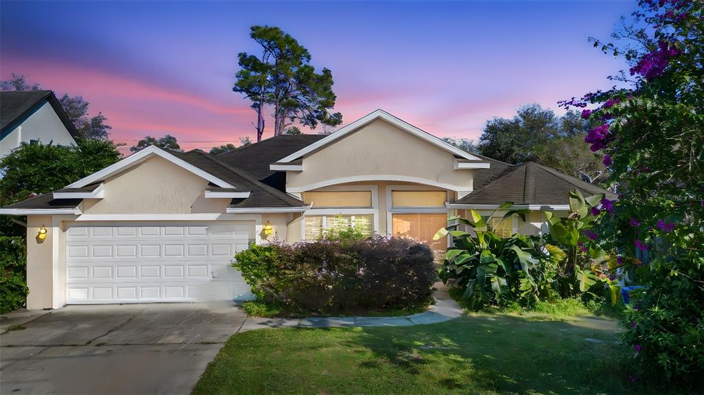 619 Rhodes Drive DeLand, FL 32720 - Photo 1 of 1 a front view of a house with a yard and garage