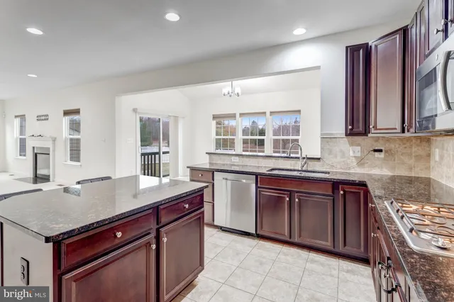a kitchen with a stove sink and cabinets