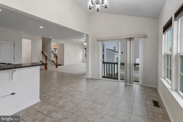 a view of a hallway with a livingroom and entryway