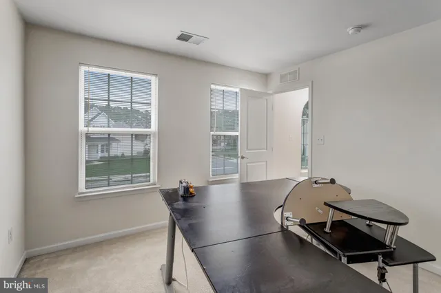 a room with gym equipment and a window