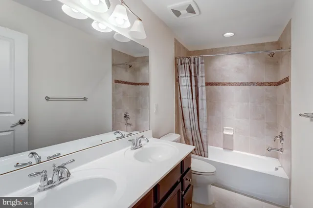 a bathroom with a sink double vanity granite tub and shower