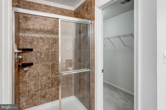 a bathroom with a glass shower door