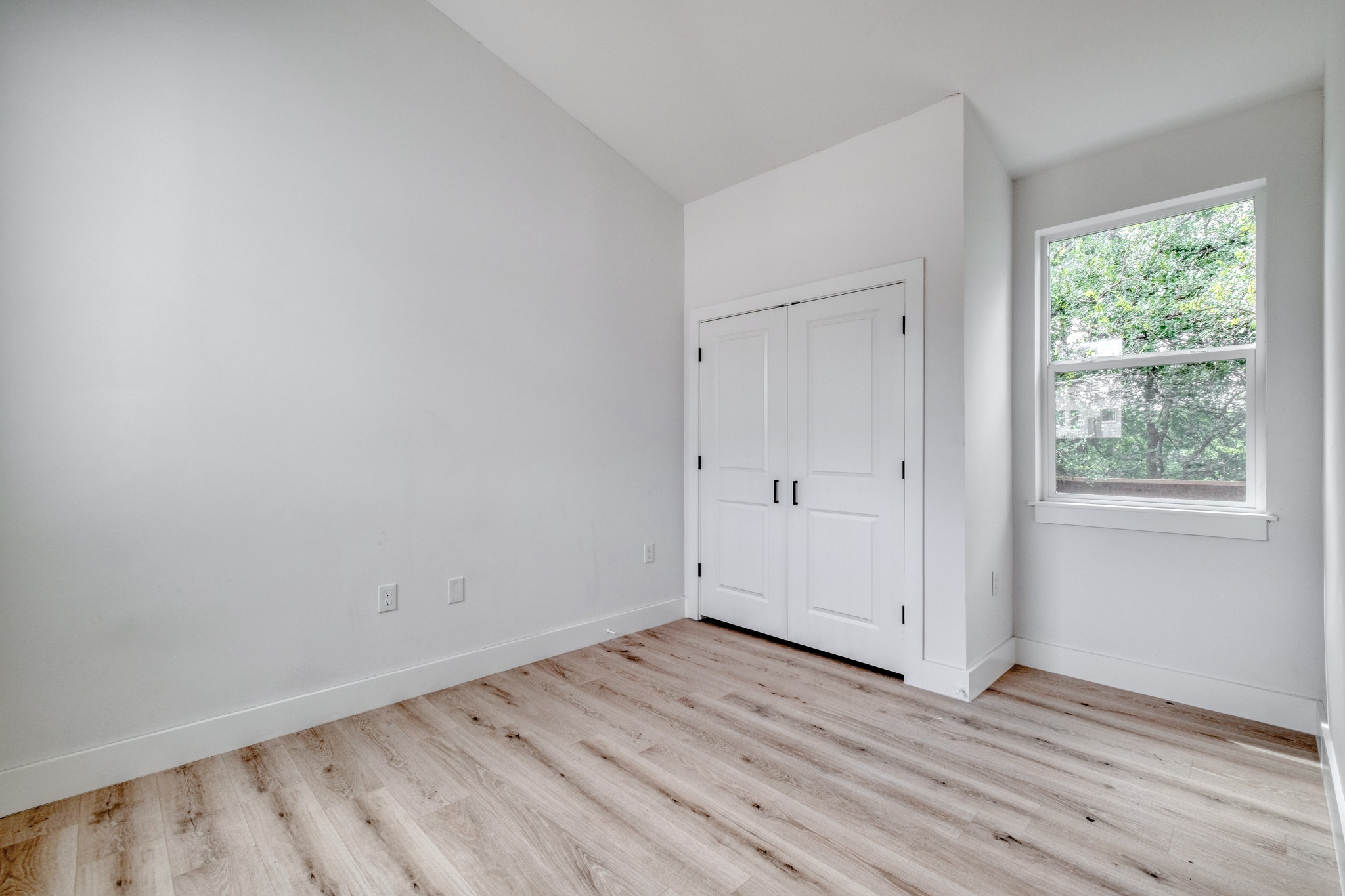 5211 Rob-Scott Street Austin, TX 78721 - Photo 11 of 24 A well-lit room showcases durable wood flooring and ample storage.
