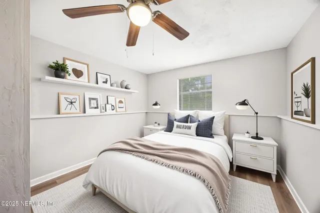 an empty room with a window and a ceiling fan