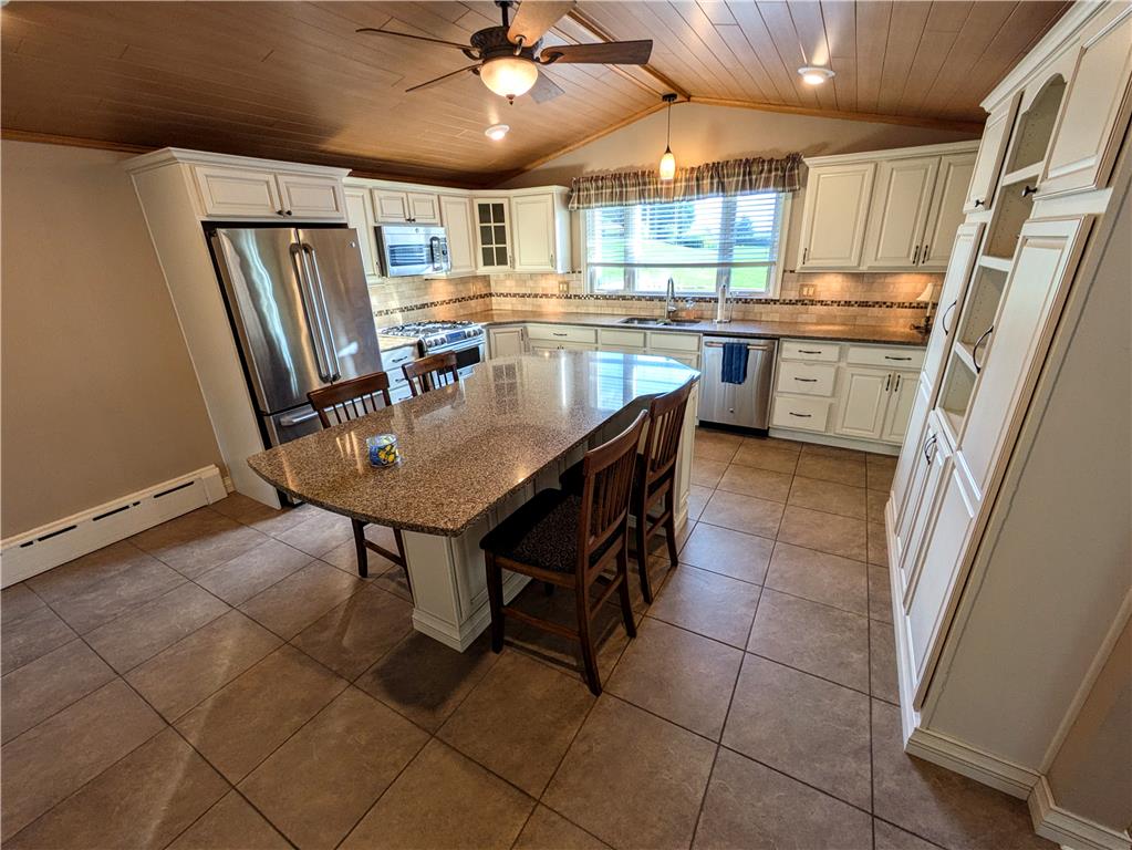 3285 Cherryville Road Northampton, PA 18067 - Photo 7 of 51 Warm laminate ceilings and durable tile floors anchor this well-appointed kitchen with central island.