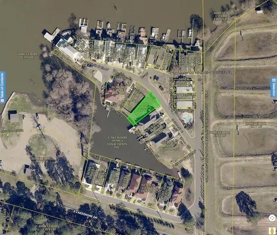 a view of yard with swimming pool and brick wall