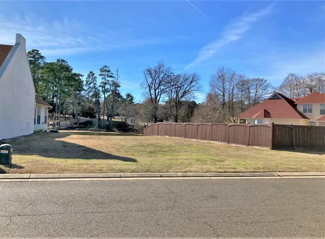 a view of a yard with a house in the background