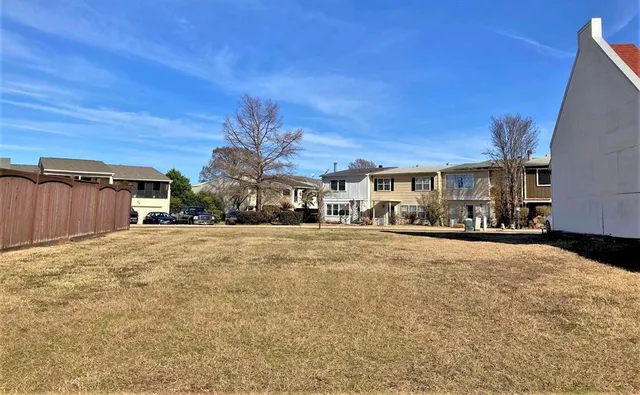 a view of a cars park in front of a building