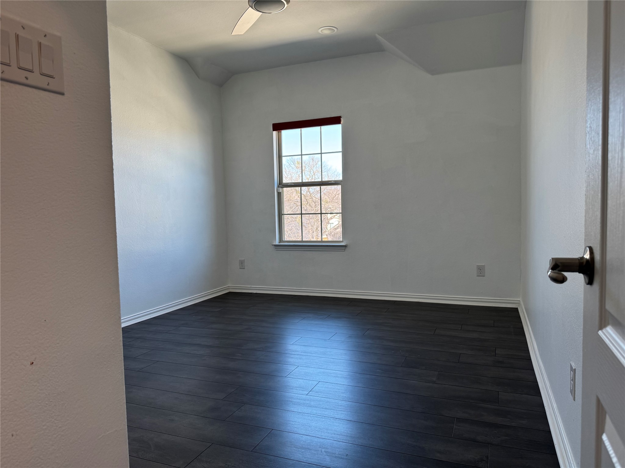 623 Pheasant Hill Lane Georgetown, TX 78628 - Photo 10 of 17 Unfurnished room featuring dark wood-style flooring, a textured wall, and ceiling fan