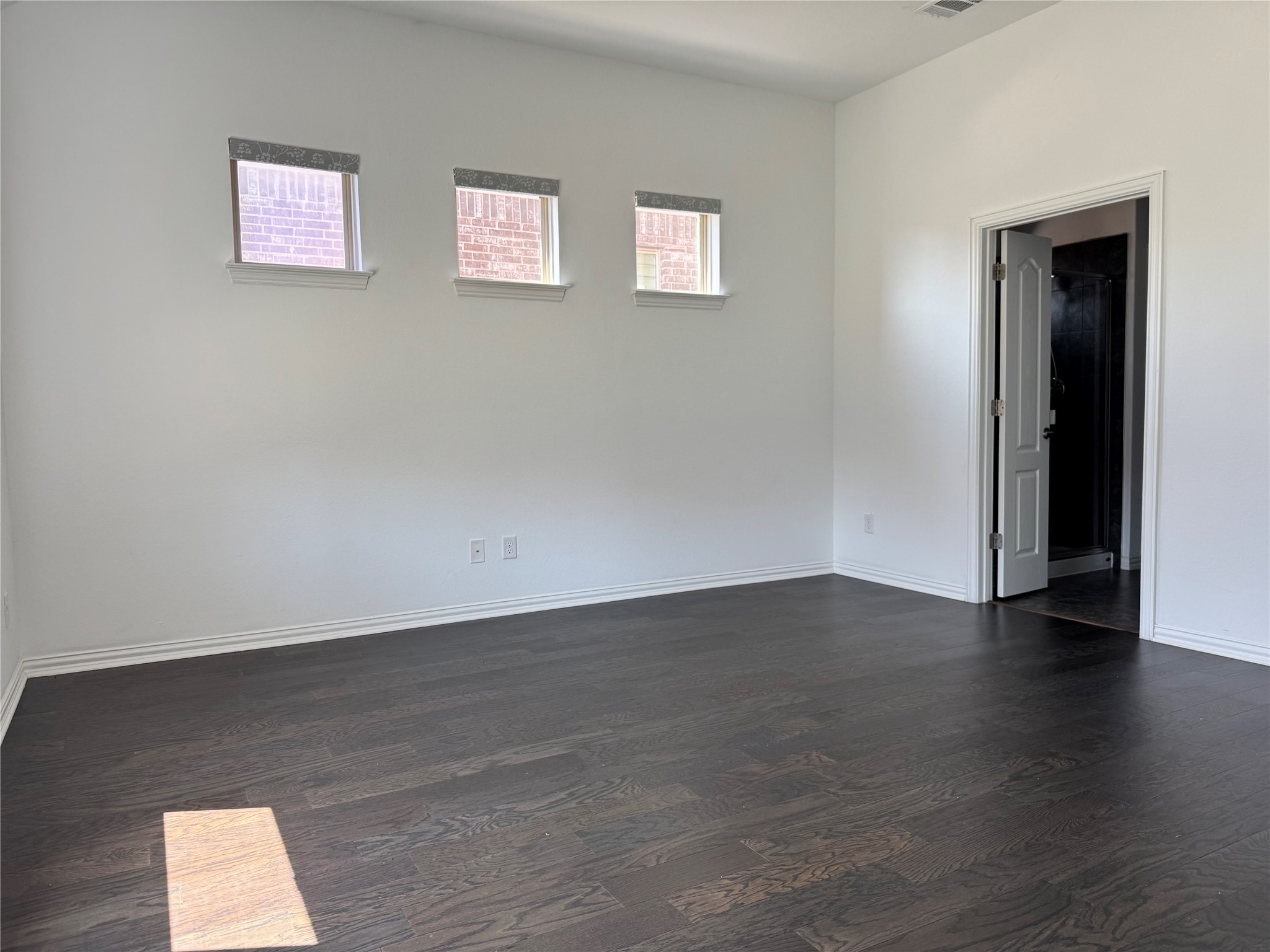 623 Pheasant Hill Lane Georgetown, TX 78628 - Photo 7 of 17 Unfurnished room with dark wood finished floors and baseboards