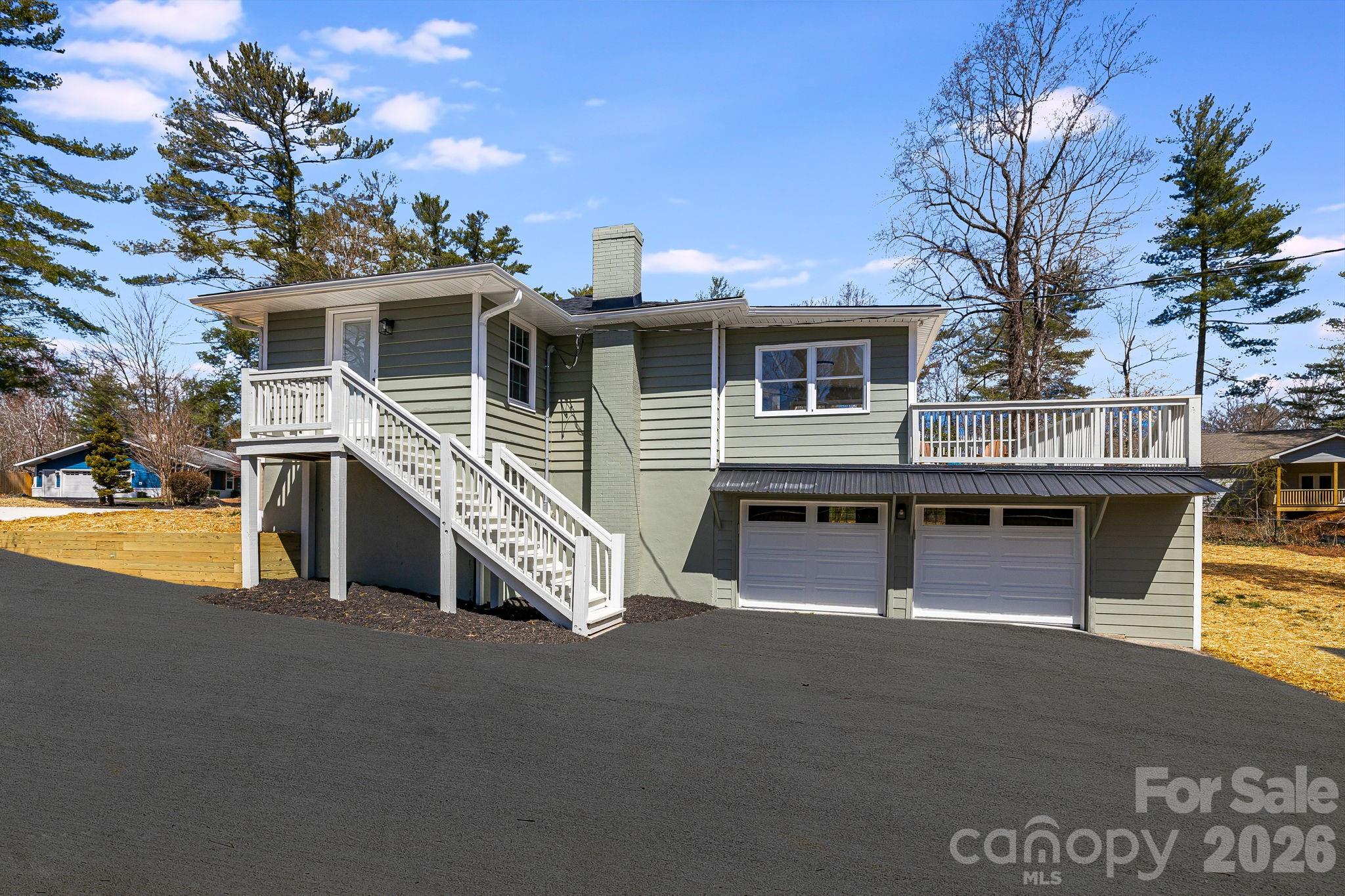 107 Balsam Road Hendersonville, NC 28792 - Photo 39 of 44 a front view of a house with glass windows