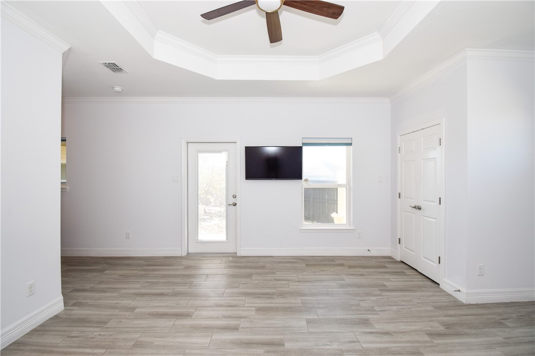 16026 Cuttysark Street Corpus Christi, TX 78418 - Photo 14 of 37 a view of empty room with wooden floor and fan
