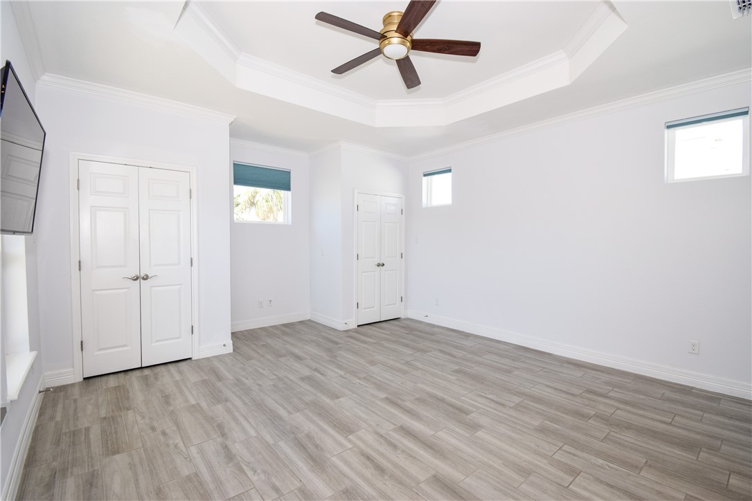 16026 Cuttysark Street Corpus Christi, TX 78418 - Photo 15 of 37 an empty room with wooden floor and windows