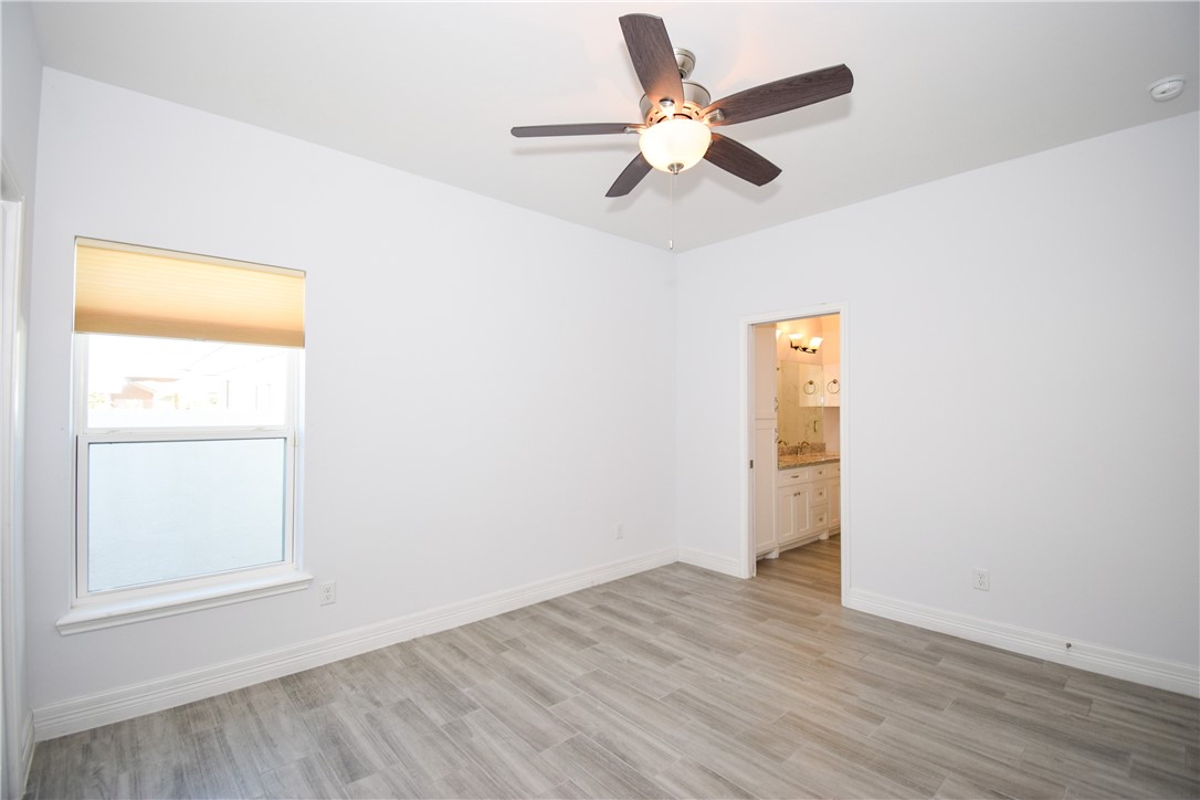 16026 Cuttysark Street Corpus Christi, TX 78418 - Photo 23 of 37 an empty room with wooden floor fan and windows