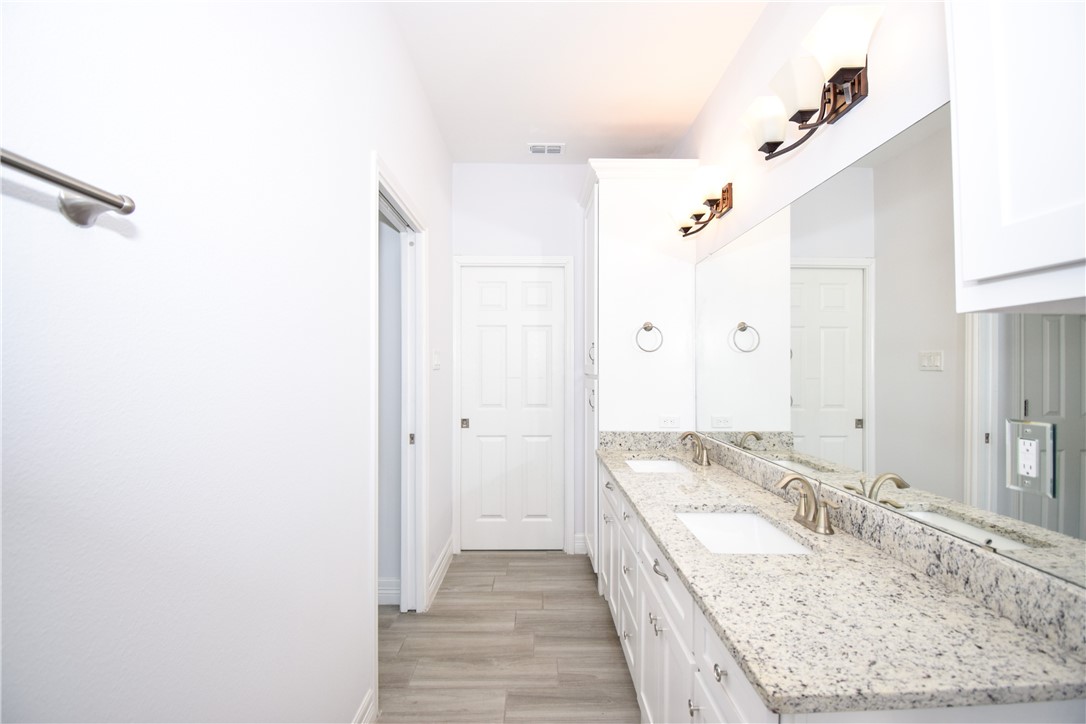 16026 Cuttysark Street Corpus Christi, TX 78418 - Photo 25 of 37 a bathroom with a granite countertop sink and a mirror