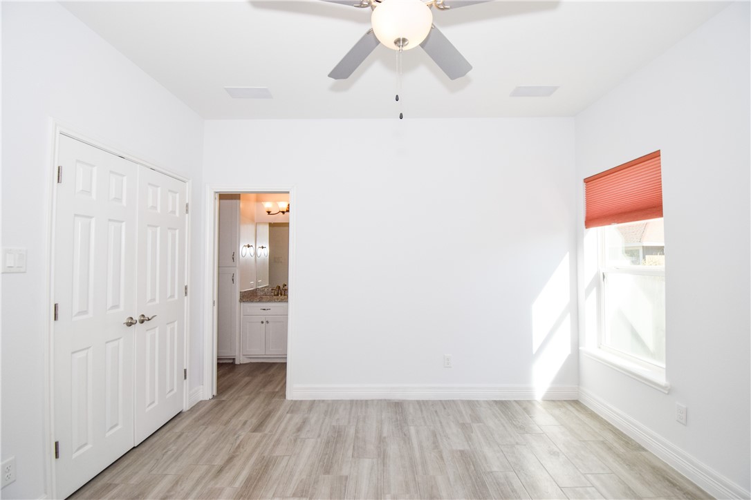 16026 Cuttysark Street Corpus Christi, TX 78418 - Photo 27 of 37 a view of a hallway with wooden floor and closet