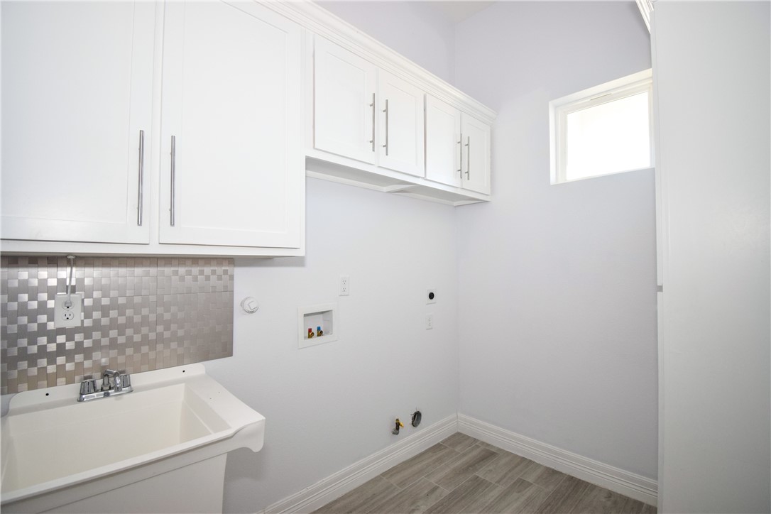16026 Cuttysark Street Corpus Christi, TX 78418 - Photo 28 of 37 a bathroom with a sink and cabinets