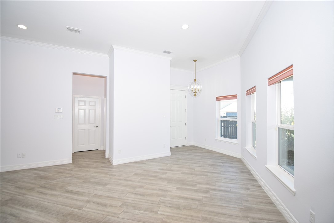 16026 Cuttysark Street Corpus Christi, TX 78418 - Photo 5 of 37 a view of an empty room with wooden floor