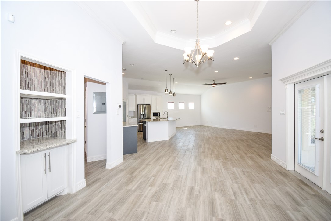16026 Cuttysark Street Corpus Christi, TX 78418 - Photo 8 of 37 a view of a kitchen with center island wooden floor stainless steel appliances and cabinets