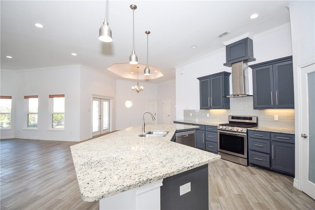 16026 Cuttysark Street Corpus Christi, TX 78418 - Photo 10 of 37 a kitchen with stainless steel appliances granite countertop counter space a sink stove and refrigerator