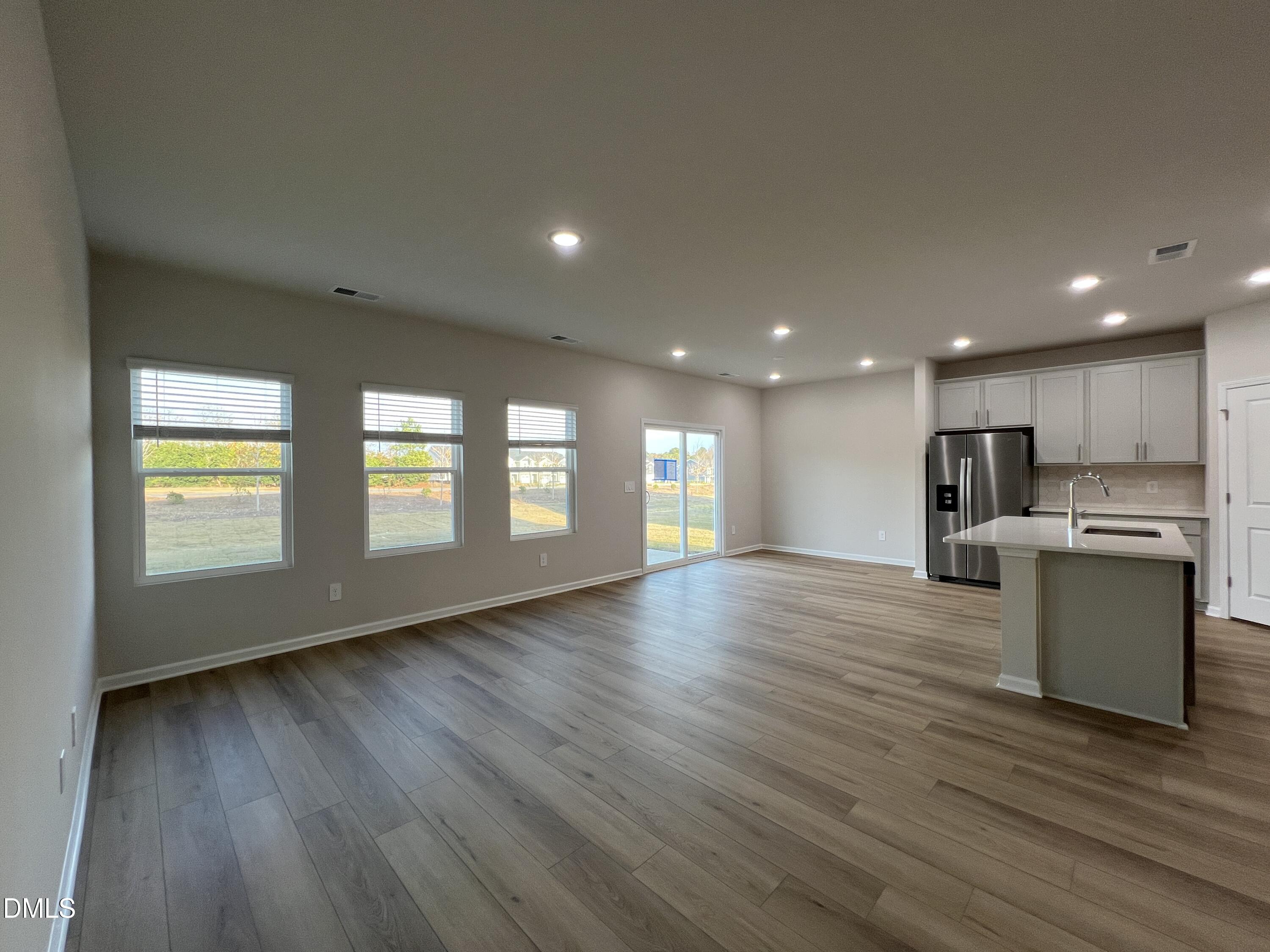 212 Thistle Patch Place Angier, NC 27501 - Photo 9 of 32 a view of kitchen with a sink wooden floor and a window
